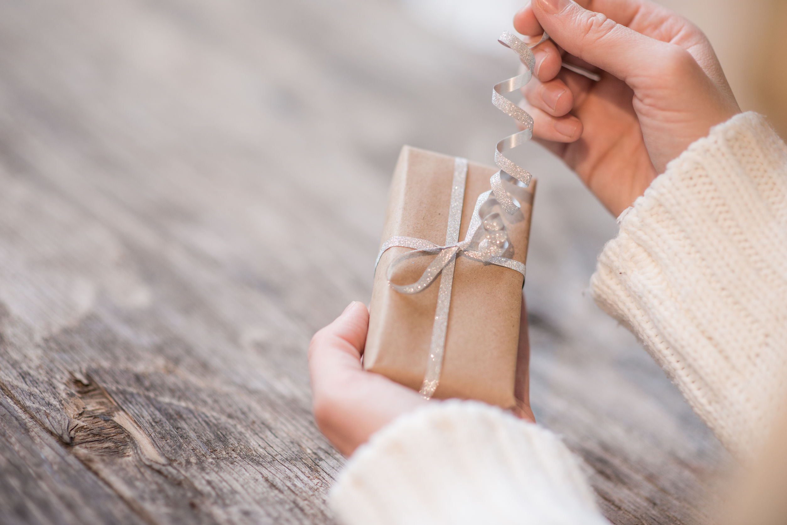 Woman's hands opening gift box for Christmas or New Year party